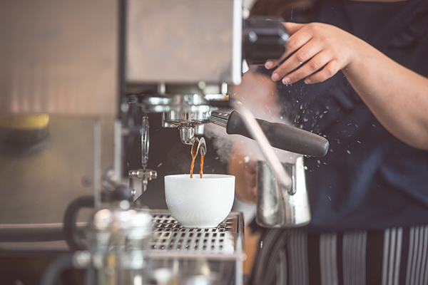 preparing coffee at espresso machine