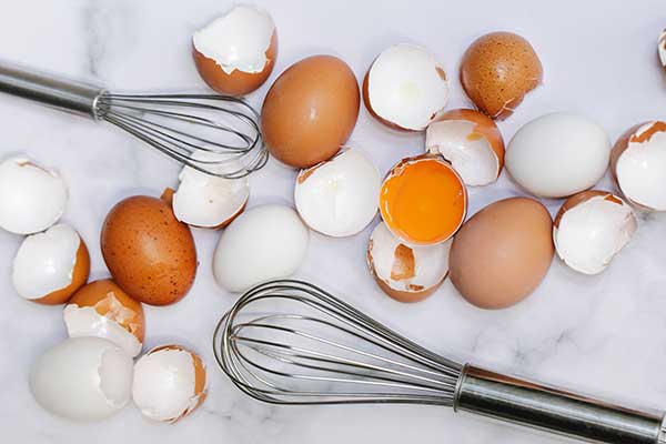 cracked eggs and whisk