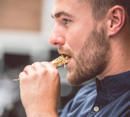 man eating granola bar
