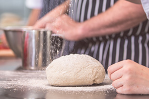 Sprinkling flour onto bread dough